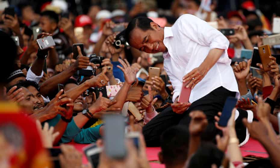 Joko Widodo takes pictures with his supporters during his first campaign rally at a stadium in Serang, Banten province in Indonesia