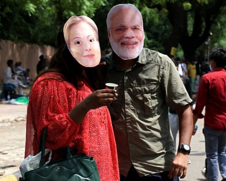 Protesters wearing masks of Modi and Giorgia Meloni.