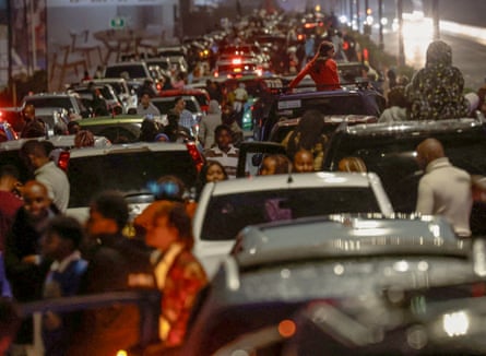 People watch from traffic as fireworks explode during New Year’s celebrations in Nairobi.