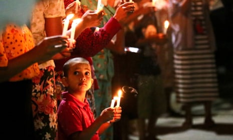 People of Myanmar hold up candlelight as part of a protest calling for the end of Military Junta