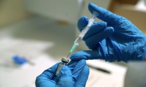 Gloved hands with a needle