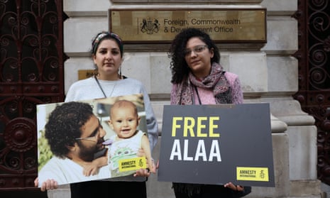 Mona and Sanaa Seif, sisters of imprisoned author Alaa Abd El-Fattah, holding placards outside the Foreign, Commonwealth and Development Office 