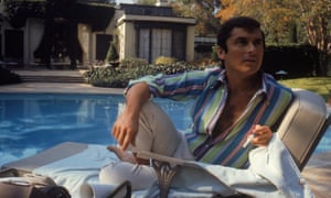 Robert Evans studying a script by the pool at his home in Beverly Hills, California, 1968.