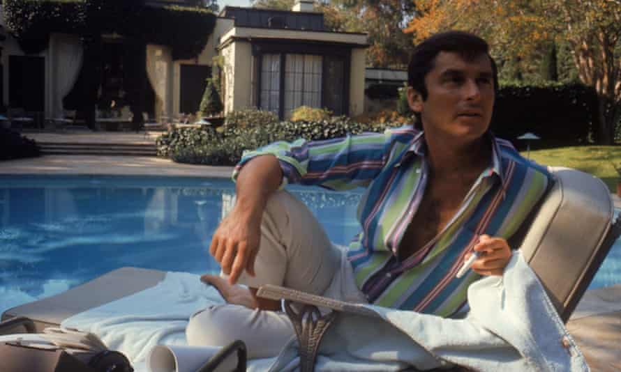 Robert Evans studying a script by the pool at his home in Beverly Hills, California, 1968.