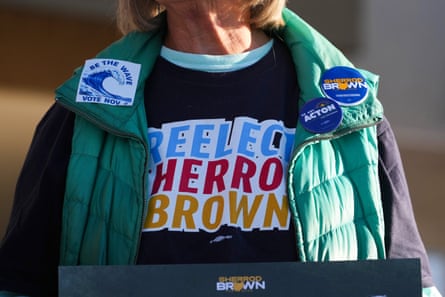 a person wears a shirt and buttons in support of Sherrod Brown
