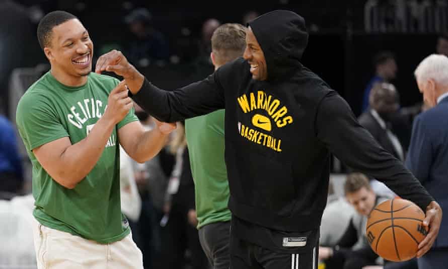 Boston's Grant Williams laughs with Golden State's Andre Iguodala during pregame warmups.