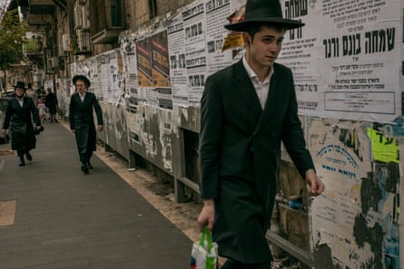 Haredi men walk down the street in Mea Shearim