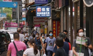 People wearing face masks walk on a street following the coronavirus disease (COVID-19) outbreak, in Hong Kong, China August 11, 2020.