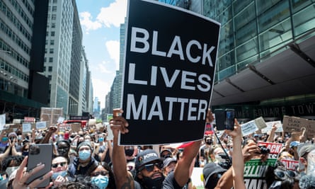An African American protester holds up a large sign that reads ‘Black Lives Matter’ in Times Square, New York, on 7 June 2020.