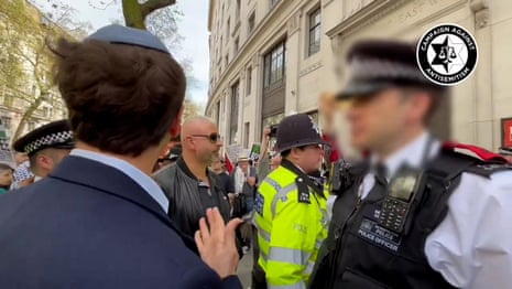 Met police officer threatens antisemitism campaigner with arrest – video