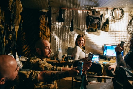 The drone pilots share out cans of energy drink during their shift.