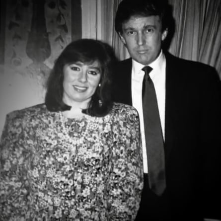 A black and white photo of Barbara Res in a flowery dress and Donald Trump in a suit standing close together, looking at the camera