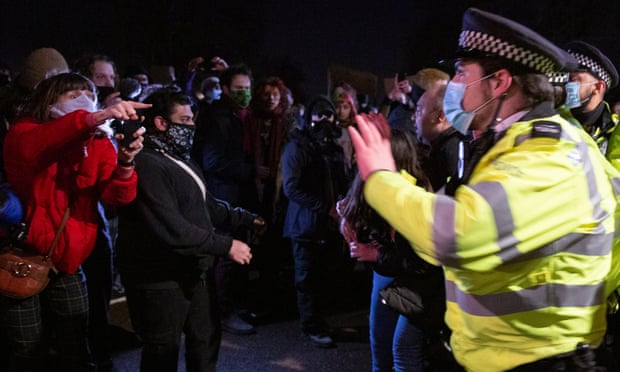 Police confront people attending the Sarah Everard vigil at Clapham Common on Saturday