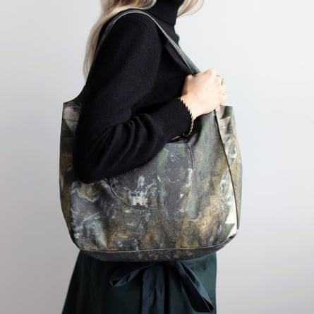 A model wears a Blue Nude abstract camo tote bag