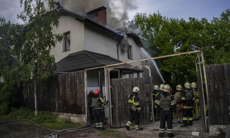 Ukrainian firefighters try to extinguish a fire in a house that was hit during a Russian attack with a cluster-type munition in Kharkiv, eastern Ukraine, Monday, May 30, 2022.