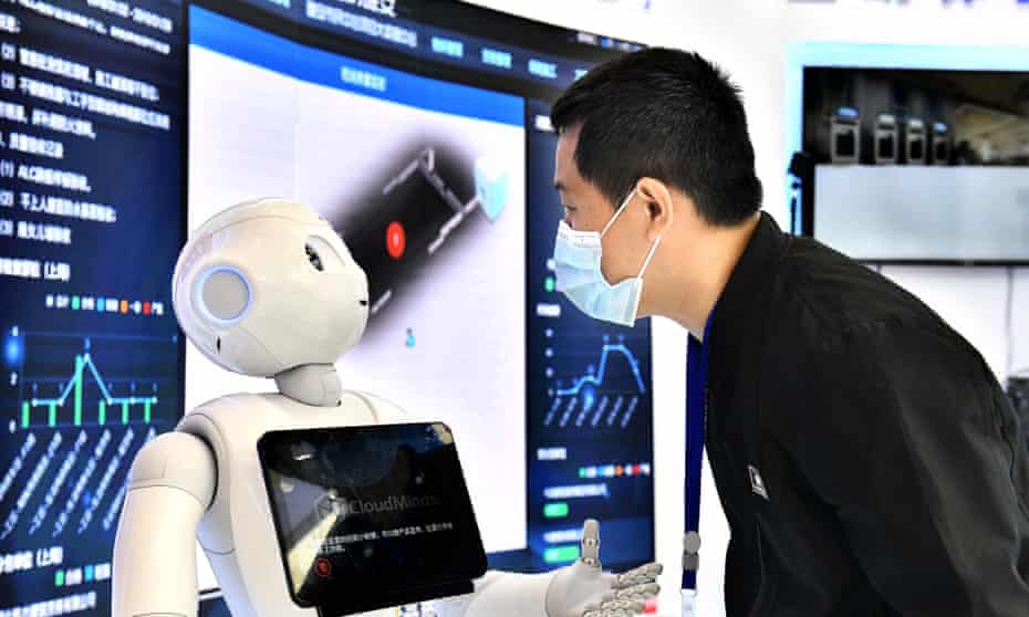 An attendee interacts with a robot during an AI summit China, April 19, 2021.
