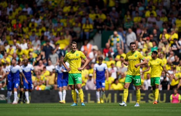 Wigan’s players in the background celebrate the opener.