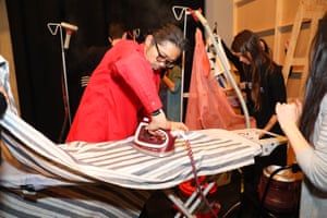Akira Isogawa ironing clothes backstage at his show, Arika, at fashion week.
