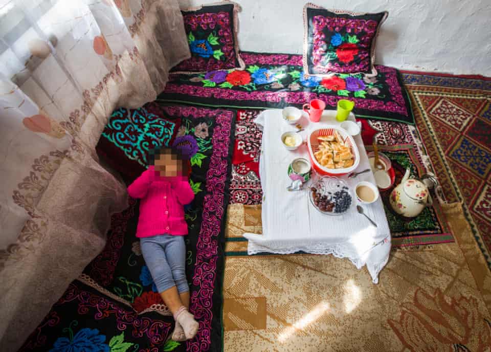 A Kazakh girl who was separated from her mother, a former detainee of an internment camp in Xinjiang