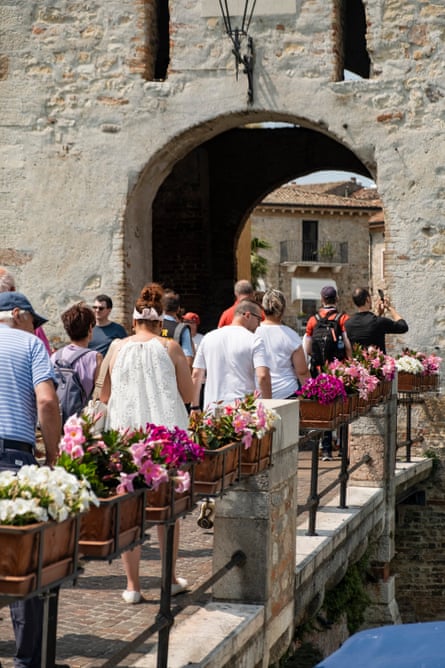Tourists walk over bridge