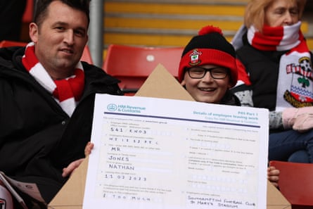 A young Southampton fan holds a mock P45 in protest at Southampton manager Nathan Jones prior to the Premier League match against Wolverhampton Wanderers at St Mary’s Stadium