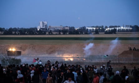 Palestinian protesters and Israeli troops at Khan Yunis in the Gaza Strip, on 4 April.