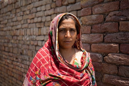 Sultana stands in her home, which was damaged by the floods last year. She is standing on the spot in the house in Sindh where she was when the roof began to collapse.