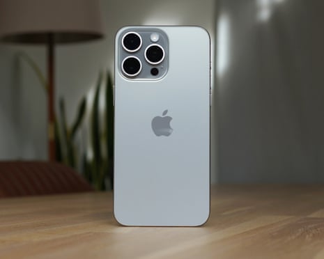 Apple iPhone 15 Pro Max review showing the glass back stood up on a table.