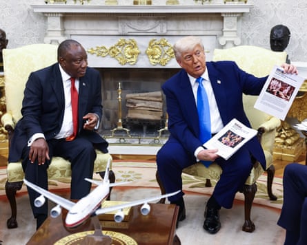 Donald Trump, right, with Cyril Ramaphosa, in the White House on yellow chairs. Donald Trump holds up printouts of news stories about farmers