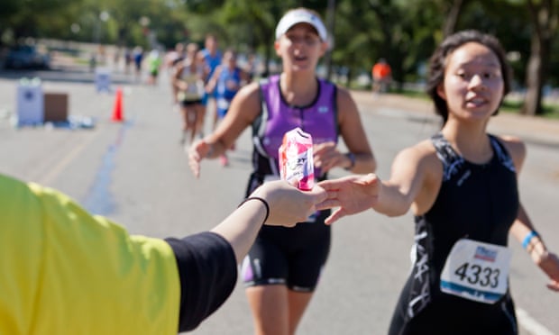 A marathon runner reaches for an energy gel