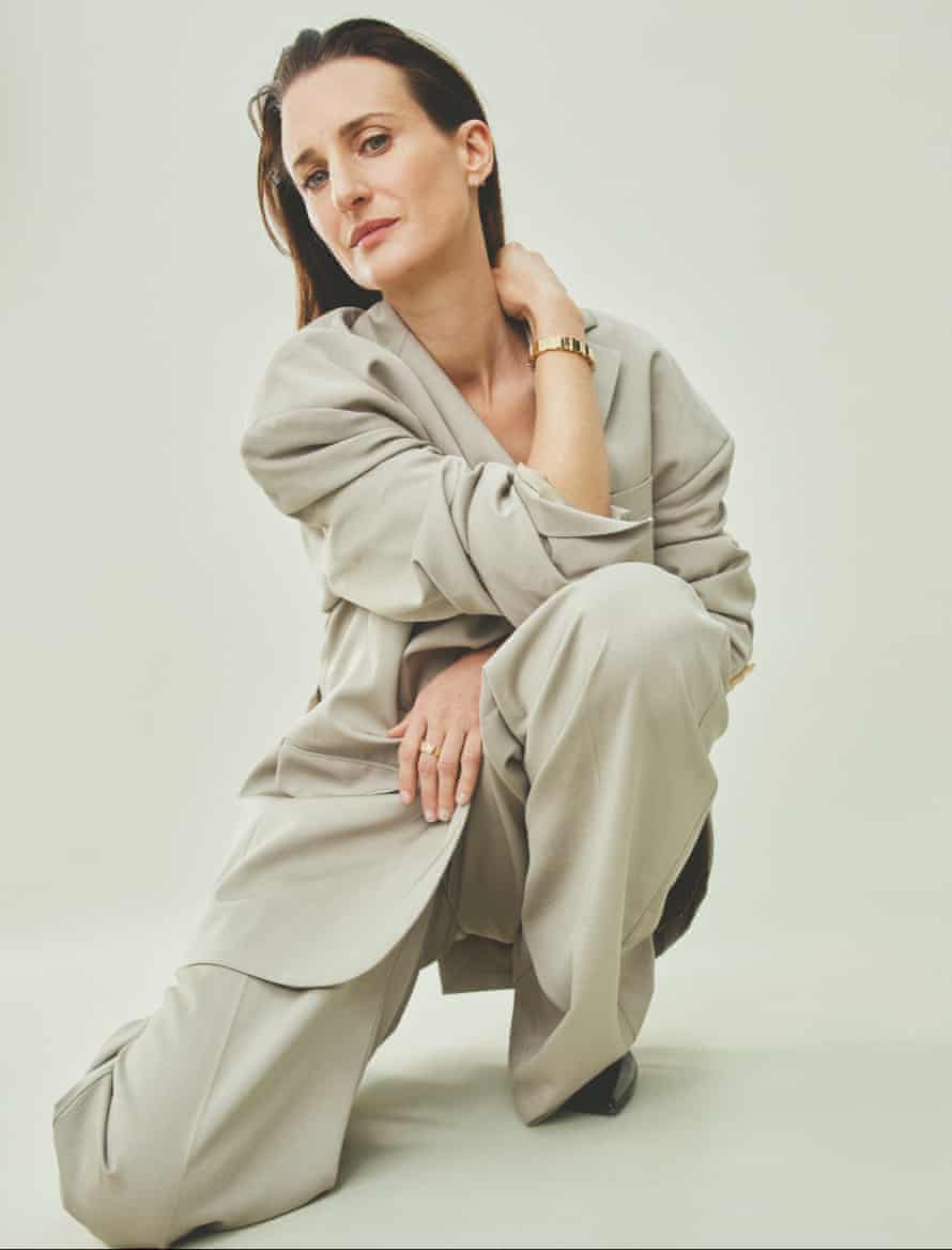 Camille Cottin in oversized suit against beige background