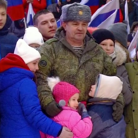 Children hug a Russian soldier 