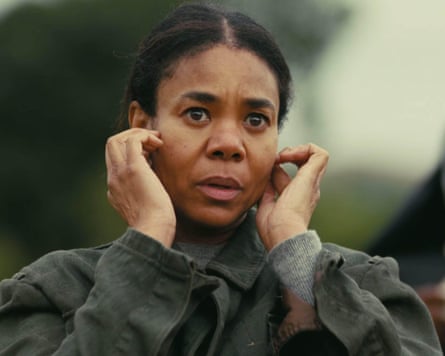 A woman looks scared as she stands outside