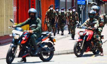 Soldiers patrol along a street in Colombo during the nationwide lockdown in Sri Lanka
