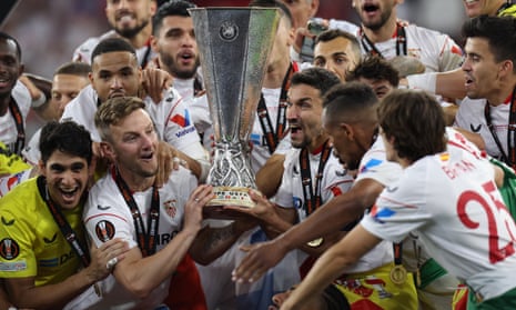 Ivan Rakitic and Jesus Navas of Sevilla lift the Europa League trophy.