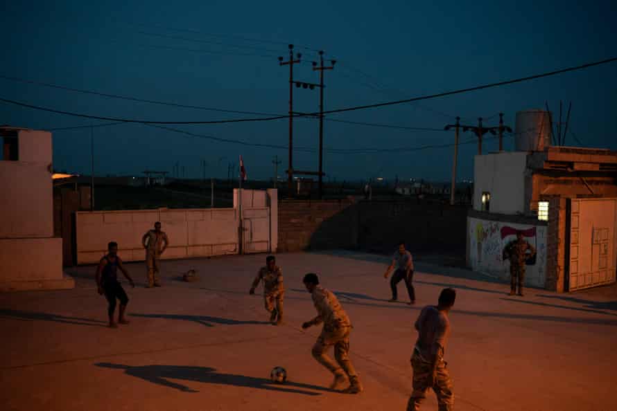Iraqi army 20th division soldiers play soccer in a military base in Badoush, Iraq.