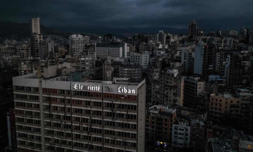 The skyline of central Beirut in near darkness with the only a few letters of the illuminated sign above the offices lit up