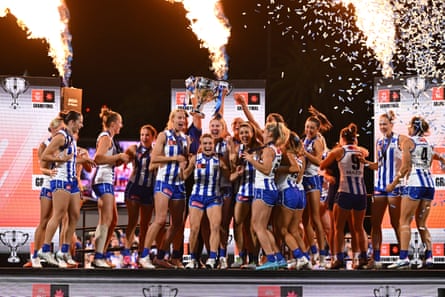 The Kangaroos lift the AFLW premiership cup after defeating the Lions in the grand final at Ikon Park