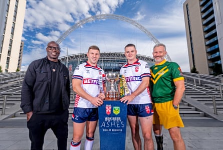 Martin Offiah and Adam Hills pose with England players George Williams and Jack Welsby.
