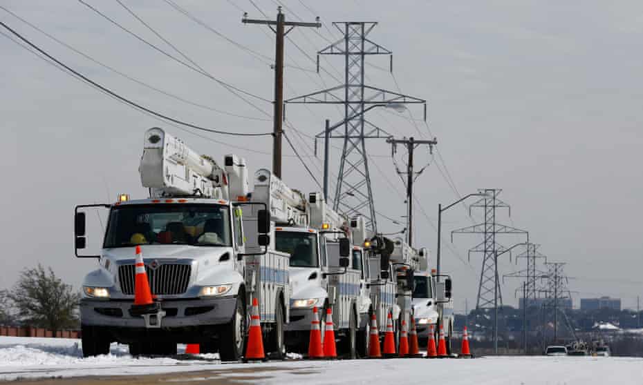 Electric utility trucks are parked in the snow in preparation of power outages due to weather in Fort Worth, Texas, this week.