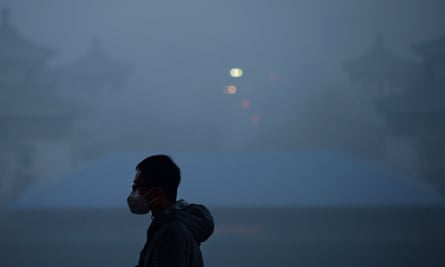 Man wearing a mask visiting a park amid heavy air pollution in Beijing.