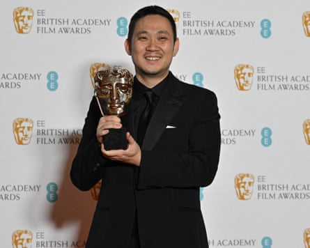 BRITAIN-ENTERTAINMENT-FILM-AWARDS-BAFTAJapanese director Ryusuke Hamaguchi poses with the award for a Film Not In The English Language for ‘Drive My Car’ shared with and Japanese producer Teruhisa Yamamoto (not pictured) at the BAFTA British Academy Film Awards at the Royal Albert Hall in London on March 13, 2022. (Photo by Ben Stansall / AFP) (Photo by BEN STANSALL/AFP via Getty Images)