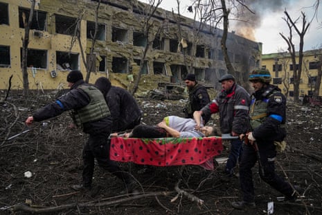Ukrainian emergency employees and police officers evacuate injured pregnant woman Iryna Kalinina, 32, from a maternity hospital that was damaged by a Russian airstrike in Mariupol, Ukraine in March 2022.