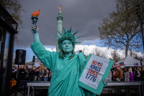 A woman dressed as the Statue of Liberty takes part in the No Kings protest in Paris, France, on Saturday.