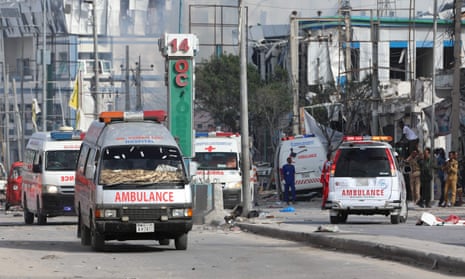 Security personnel and ambulances near the blast site after a car bombing targeted the education ministry in Mogadishu, Somalia