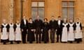 Downton Abbey cast members lined up in a row outside the house