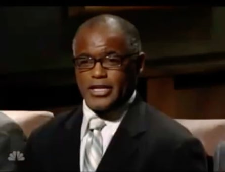 A head and shoulders shot of Gene Folkes on television, wearing a suit