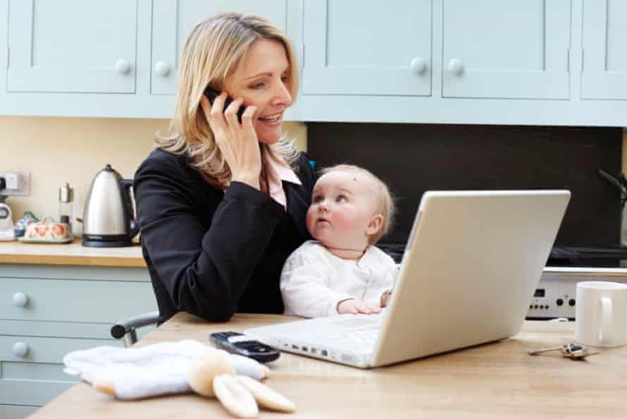 A woman working at home with a baby