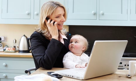 woman working from home with baby in her arms