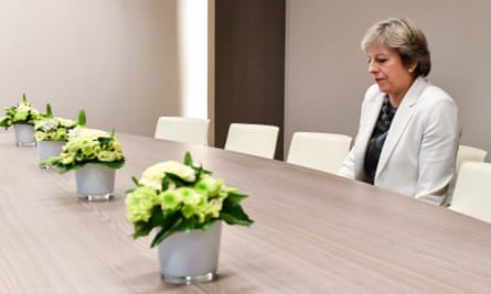 May takes a seat as she arrives for a bilateral meeting with European council president Donald Tusk on 20 October 2017.